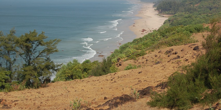 View of Ganapatipule beach, a popular destination near Purnagad fort, with sandy shore.