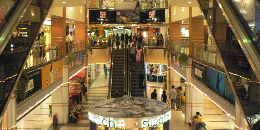Shoppers exploring the vibrant stores and lively atmosphere inside Garuda Mall, Bangalore.