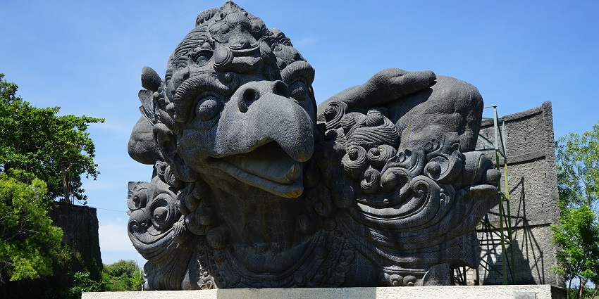 Garuda Wisnu Kencana statue in Bali, standing tall under a clear blue sky