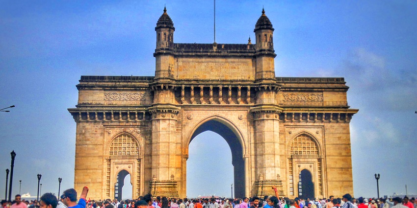 The Gateway of India, a monumental arch, stands majestically by the waterfront