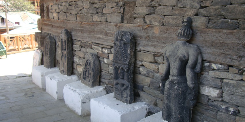 Five intricately carved stone statues near Gauri Shankar Temple on square pedestals