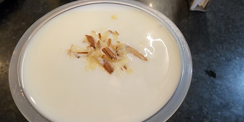 An image showing a glass of refreshing lassi offered.