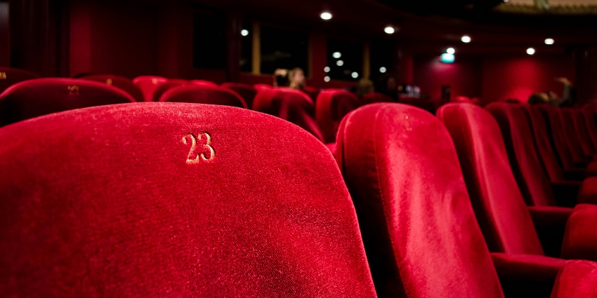 Picture clicked while the people watching a cinema in a crowded movie theatre.
