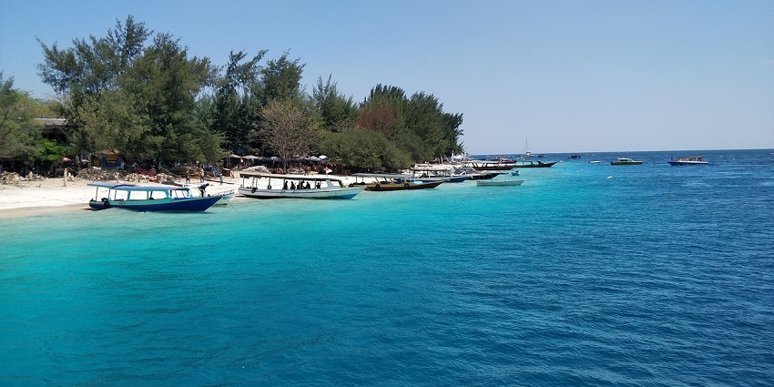A picturesque view of Gili Trawangan Island with turquoise waters and sandy shoreline