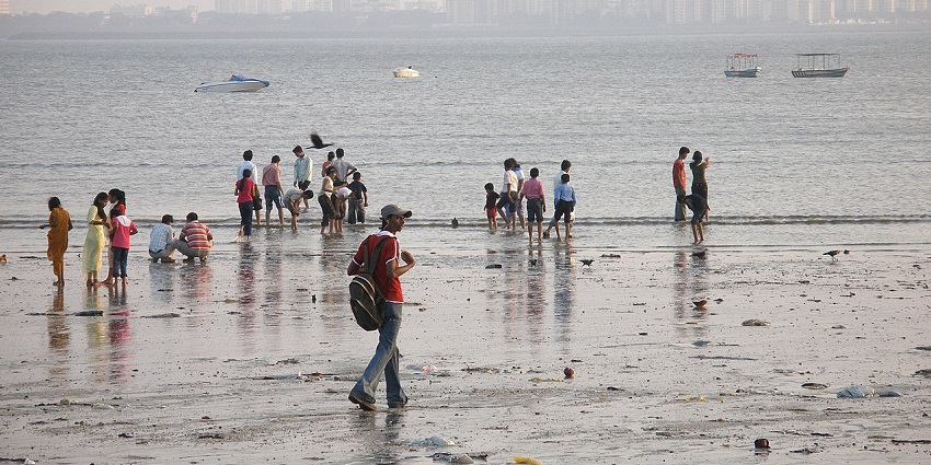 An image of Girgaon Chowpatty Beach in Mumbai, a popular spot for locals and tourists to relax by the Arabian Sea.