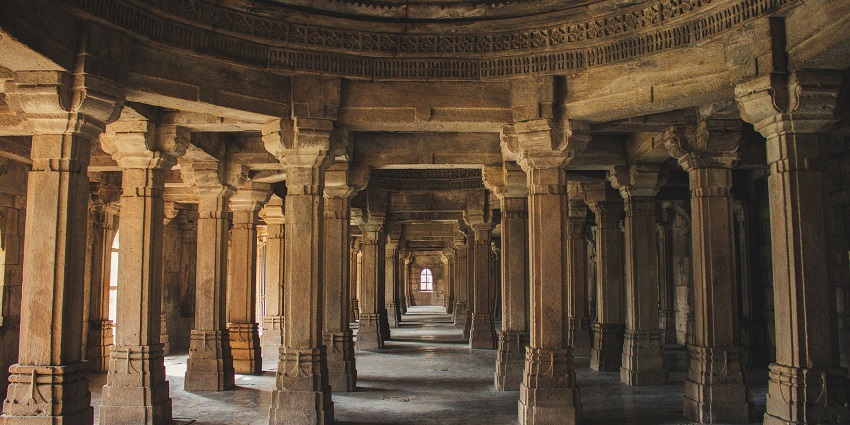 An image of the intricate architecture of Gnanapureeswarar Temple set against a clear blue sky