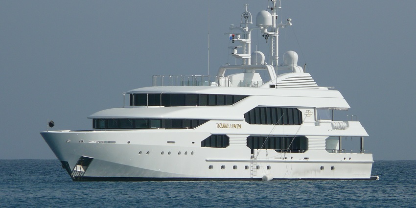 View of the from afar yacht sailing on the serene water
