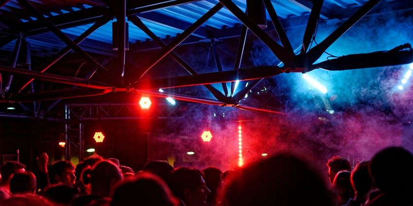 A glimpse of the Goafornia Beach Lounge featuring colourful neon lights and a crowd.