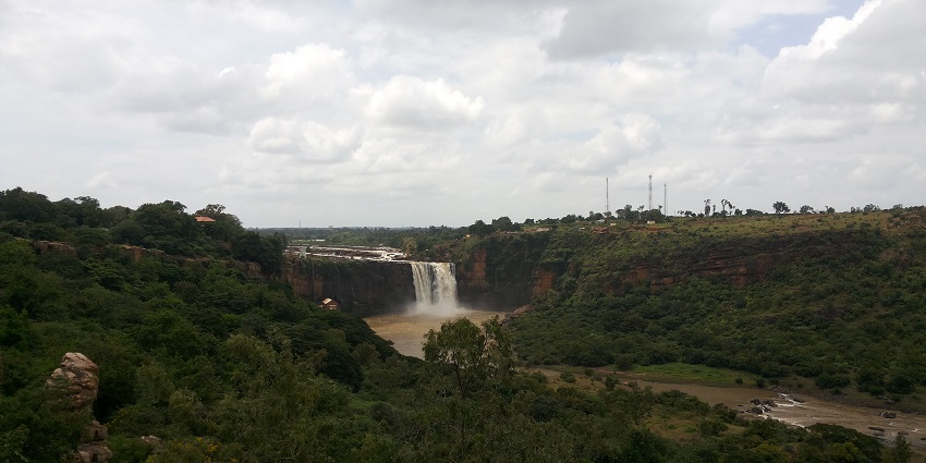 A distant view of Gokak Falls, capturing its cascading waters and surrounding landscape.