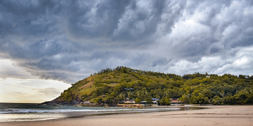 Scenic view of Gokarna's coastline, with sandy beaches, lush greenery, and gentle waves.