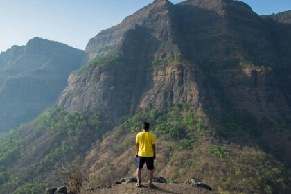 An image showing a majestic trekking hills under a clear blue sky - Gorakhgad Fort