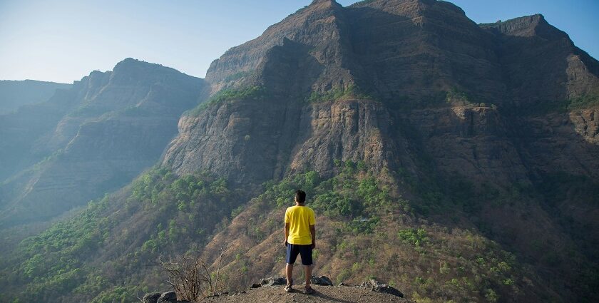 An image showing a majestic trekking hills under a clear blue sky - Gorakhgad Fort