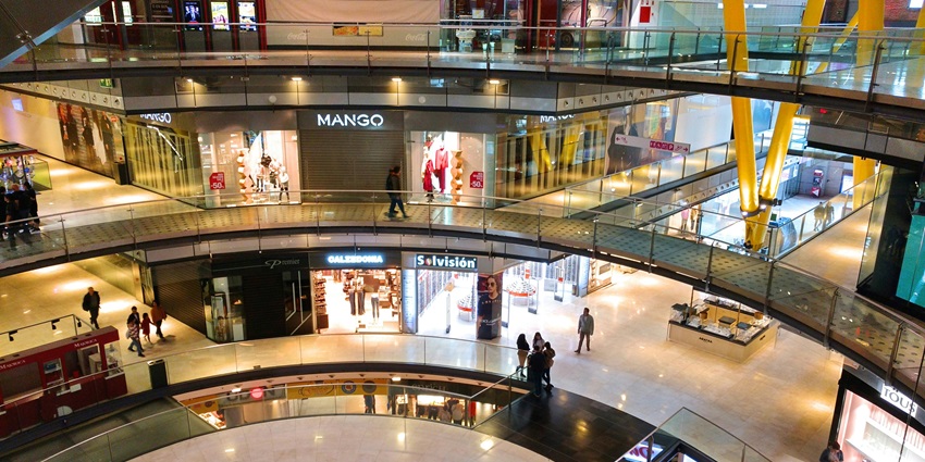 An inside view of the Grand Square Mall featuring retail stores and branded shops.