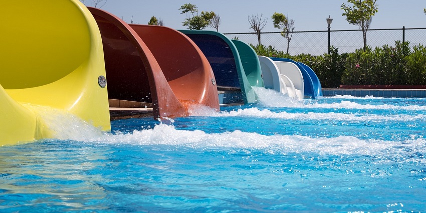 An image of a child happily playing in an inflatable pool, splashing water joyfully.