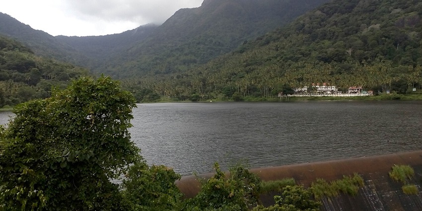 A picturesque reservoir surrounded by lush greenery, offering a peaceful retreat for visitors, one of the best places to visit in Tenkasi.