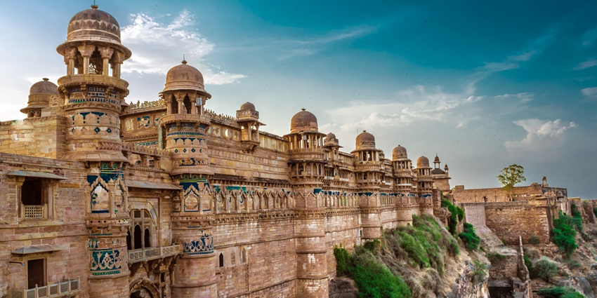 A picture of the historical Gwalior Fort with intricate wall carvings and traditional architecture