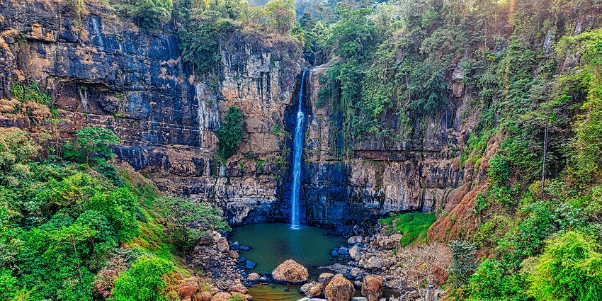 An image of Gwarighat Waterfall, surrounded by lush greenery, ideal for picnics.