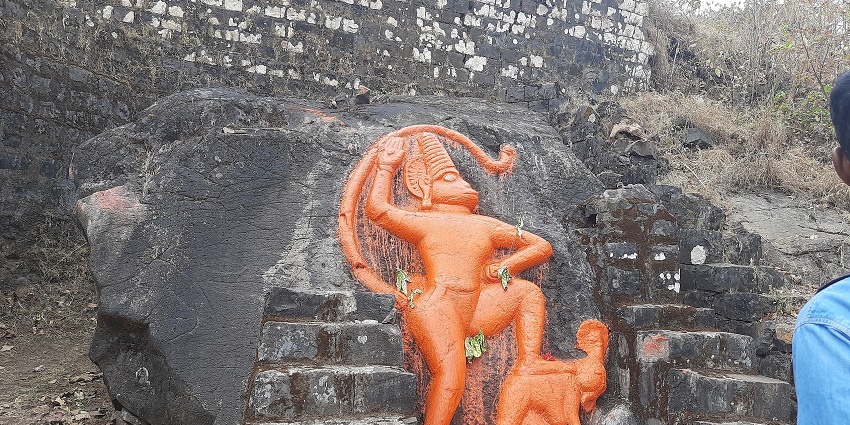 An aerial view of the idol of lord Hanuman covered with a clear sky located in the city.
