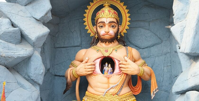 A serene statue of a man in a cave, reminiscent of Hanuman temples in Pune.