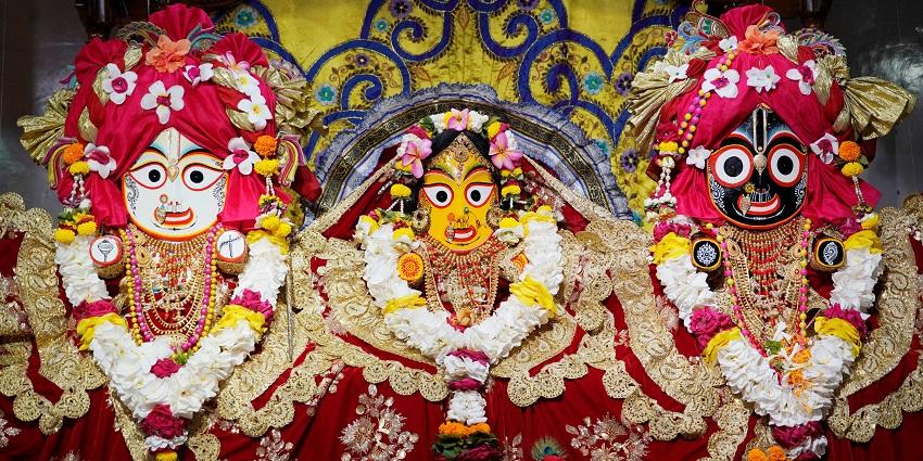 A picture of a temple mandap with decorated idols of Lord Krishna and Goddess Radha