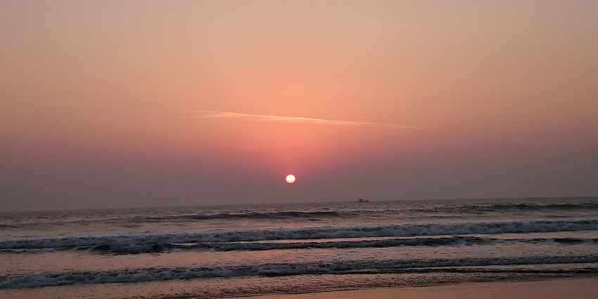 Stunning sunset view of Harihareshwar Beach with serene waters.