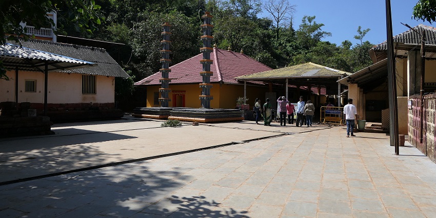 View of the ancient Harihareshwar Temple showcasing people roaming around it, a best place near Nangartas Waterfall