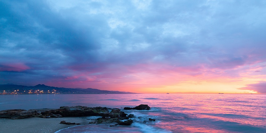 A breathtaking vista of sun settling down with colourful hues at the Harihareshwar Beach.