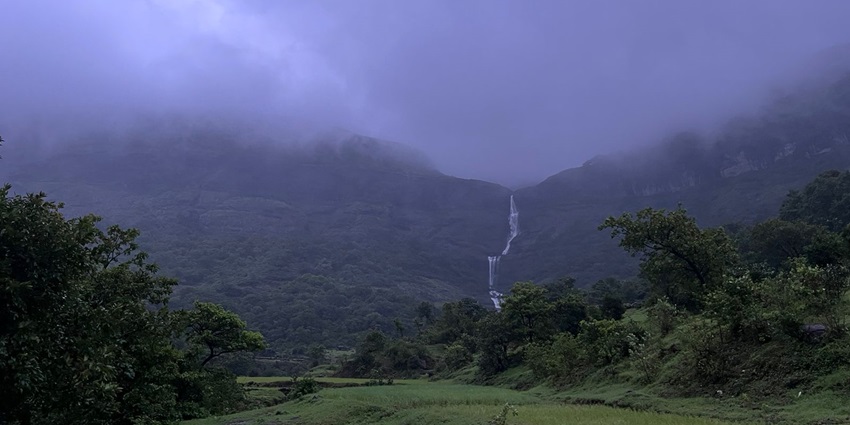 A view with hills, trees, and blue sky near one of the famous waterfalls in Maharashtra.