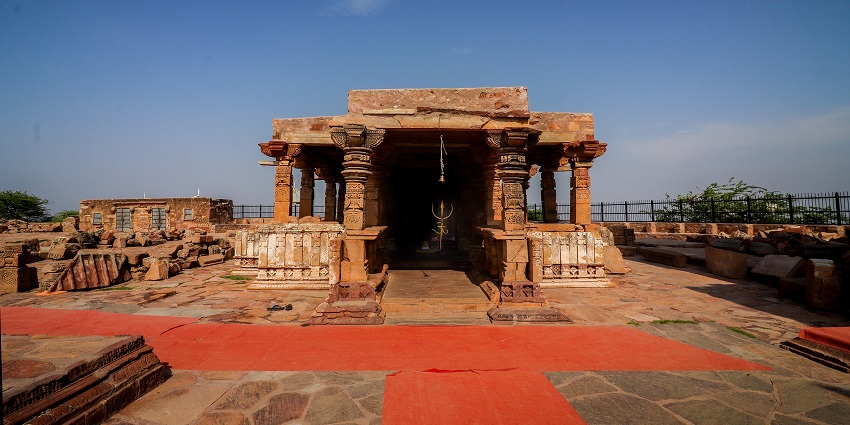 Outside of Harshnath Temple in Sikar with architectural details against a blue sky.