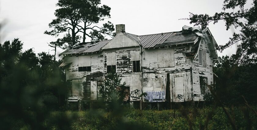 A glimpse of a spooky house nestled in Maharashtra surrounded by lush greenery.