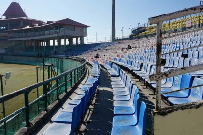 A picture showing a cricket stadium in Thane with tall buildings visible in the background.