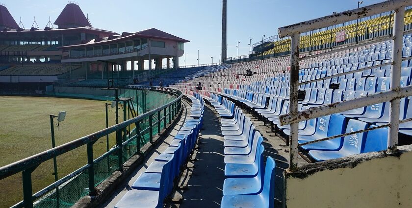 A picture showing a cricket stadium in Thane with tall buildings visible in the background.