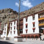 The beautiful exterior of Hemis Monastery during a clear day in Ladakh, surrounded by mountains.