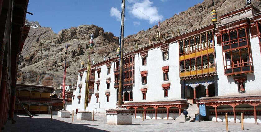 The beautiful exterior of Hemis Monastery during a clear day in Ladakh, surrounded by mountains.