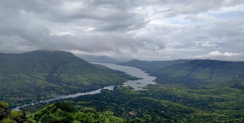 View of Mahabaleshwar, highlighting its rolling hills and vibrant landscape under a clear sky.