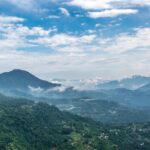 A picture of a lush green mountain near Hosur with numerous mountains in the background