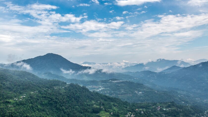 A picture of a lush green mountain near Hosur with numerous mountains in the background