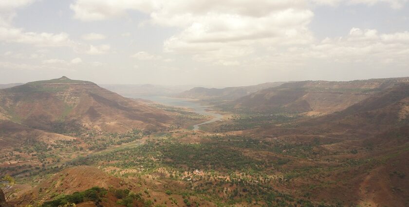 A panoramic view of Panchgani and Mahabaleshwar, featuring hills and valleys under clear skies.