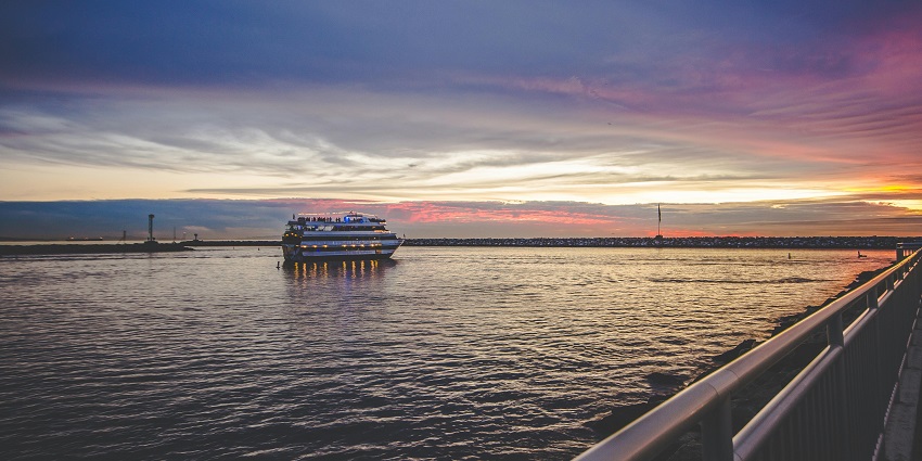 Photo of Cruise Ship on Sea during sunset hour with beautiful views on the sky and sea