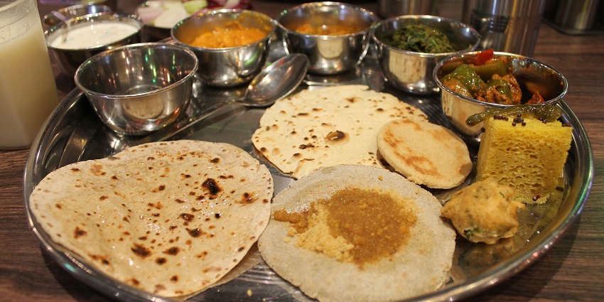 A traditional Rajasthani thali inclusive of curries, roti, and side accompaniment is one of the best food items in Lonavala
