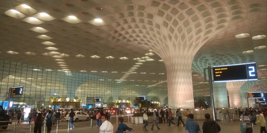 A view of Mumbai International Airport designed with modern art and high ceilings.