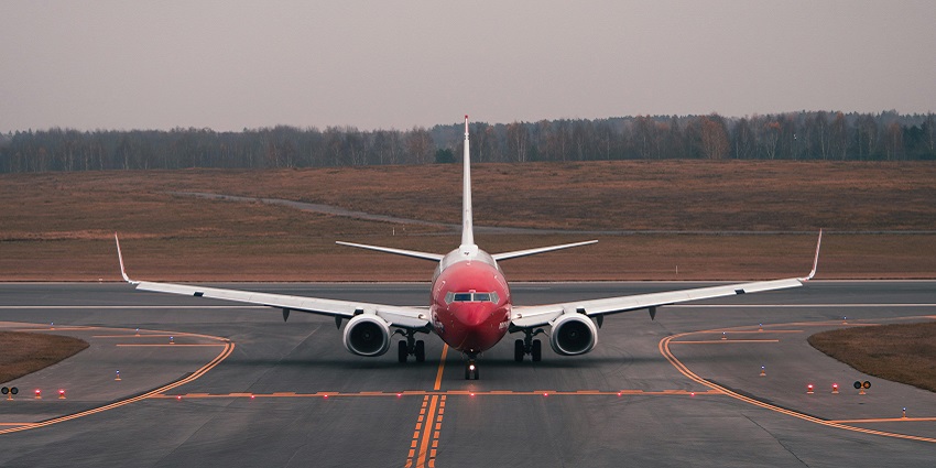 An image of a plane along the coastal road, guiding you on how to reach Amed Beach.