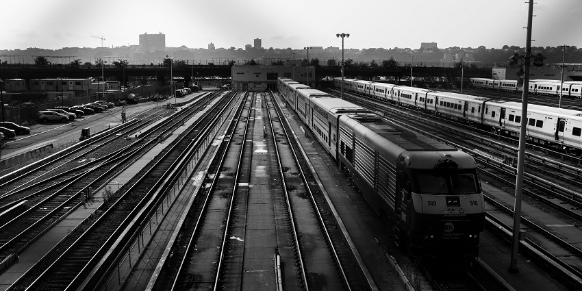 Gray-scale image of a train in motion, showcasing its sleek design and power.