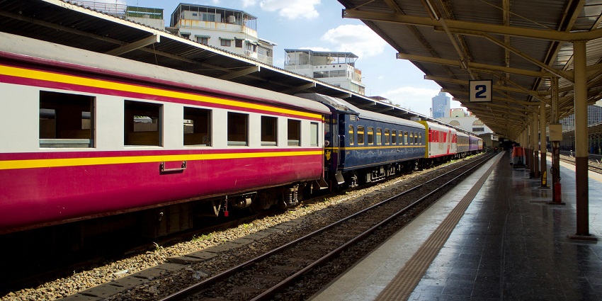 Train arriving at the station, with railroad tracks extending into the distance,