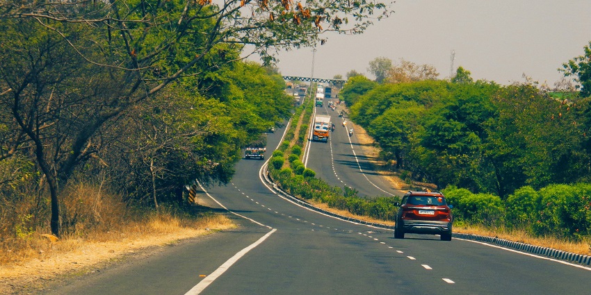 Road to Ankai Fort in Maharashtra with lush greenery around and against a clear blue sky.