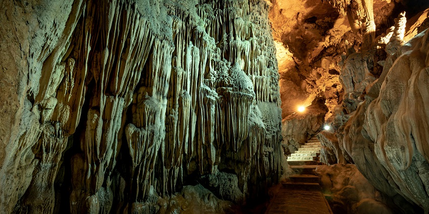 Image showcasing the scenic interiors of the Bhamchandra Caves with stairs and carvings