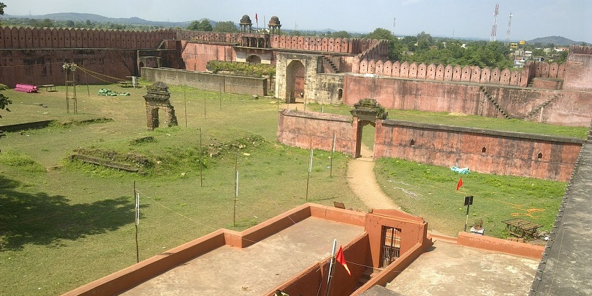 A panoramic view of Nagardhan Fort surrounded by greenery under a clear blue sky