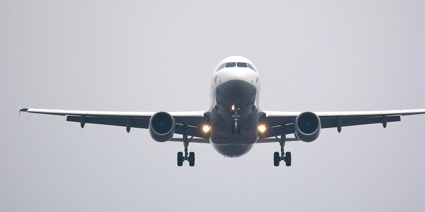 A view of a white aeroplane taking off in the blue sky in Maharashtra, India.