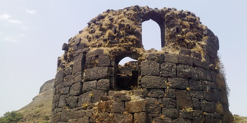 The grand entrance of Ratangad Fort, featuring ancient stone architecture and lush greenery