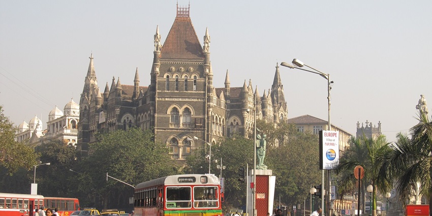 Fort Road in Mumbai, showcases a bustling urban street with buildings and vehicles.